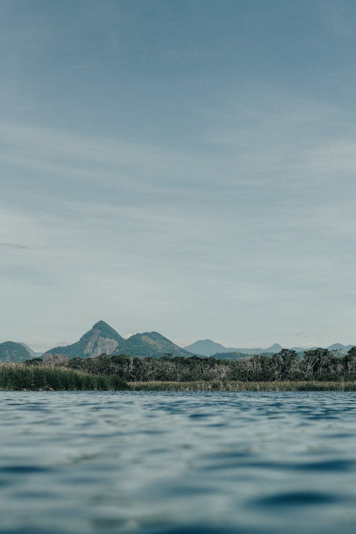 services-01 Peaceful landscape featuring a lake, mountains, and clear sky, perfect for nature lovers.